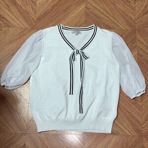 White blouse with blue and white bow